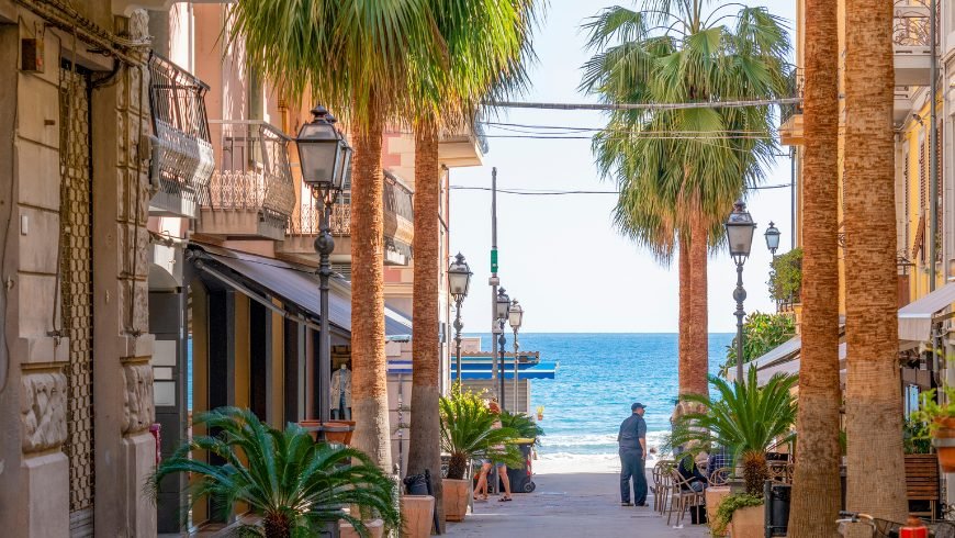 A palm-lined street leading to the sea at Alassio