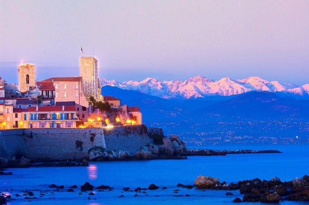 The old town of Antibes and the Alps at dusk