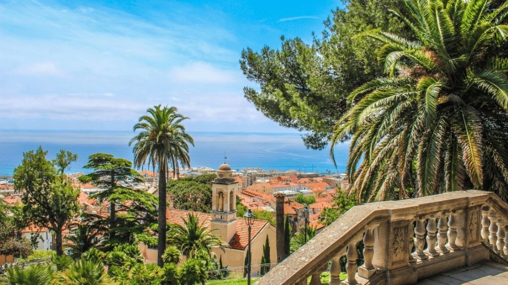 Palms and the old town above the sea at Sanremo